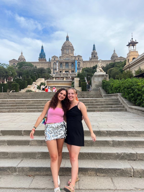 Two people pose on steps of Spanish landmark