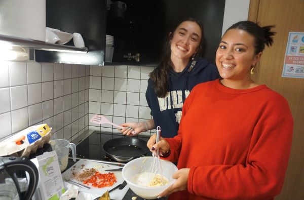 Two study abroad students making pancakes