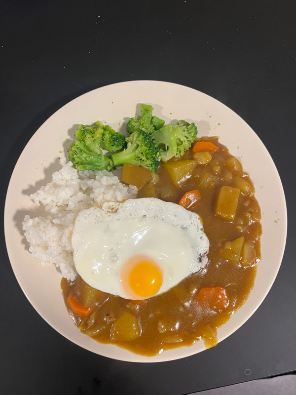 A plate of food with a fried egg and rice