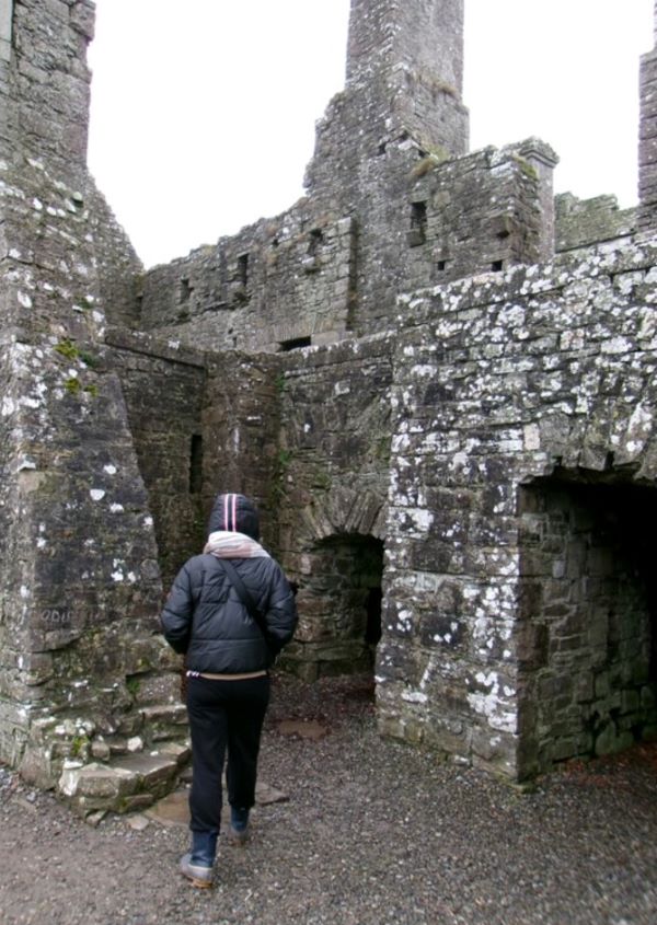 Study abroad student walking into a medieval ruin