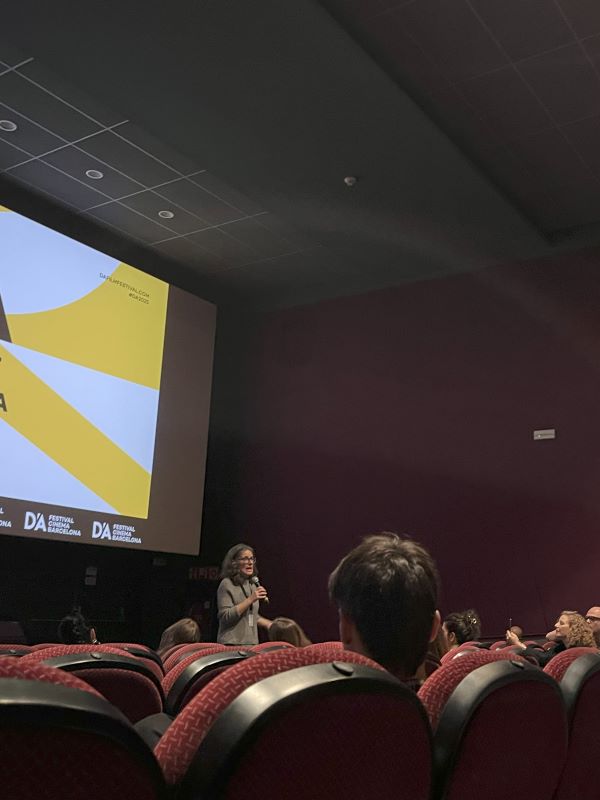 Woman speaking to a theater full of people