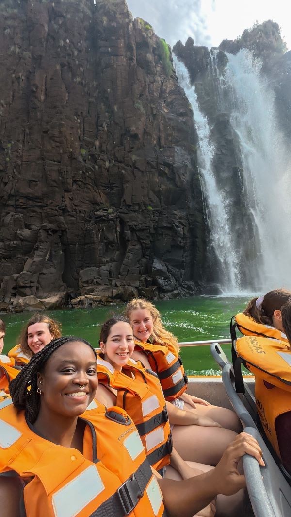 Three study abroad students taking a selfie while seated on a boat