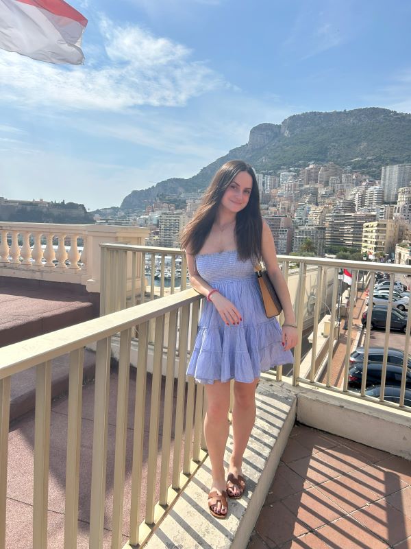 Study abroad student posing for photo with view of city in background