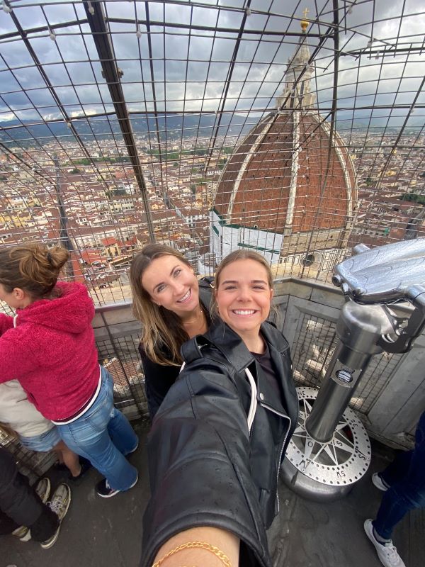 Selfie of two study abroad students on high rise with view of Florence