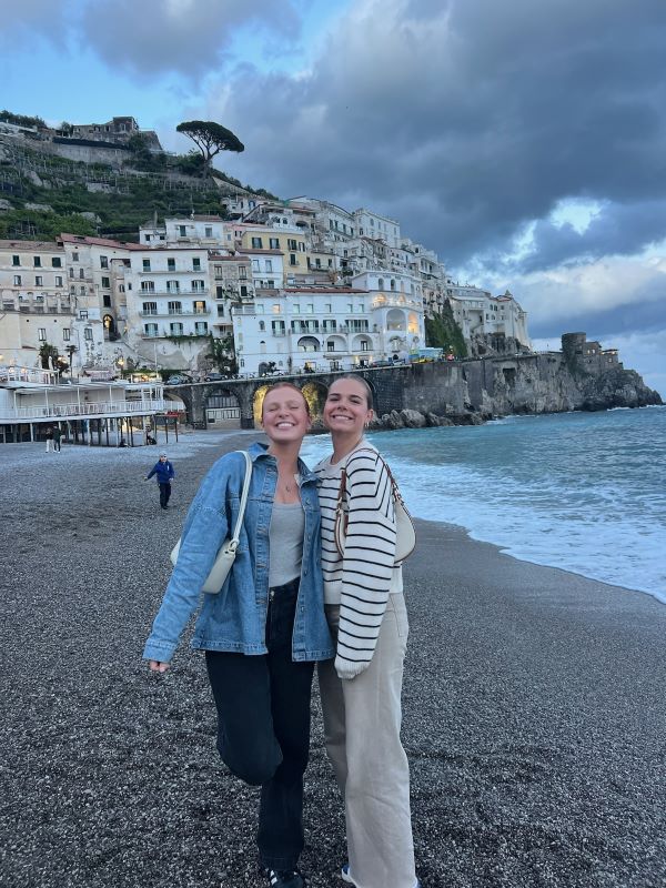 Two study abroad students posing for photo on rocky beach