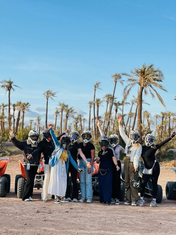 Study abroad students posing for photo with helmets