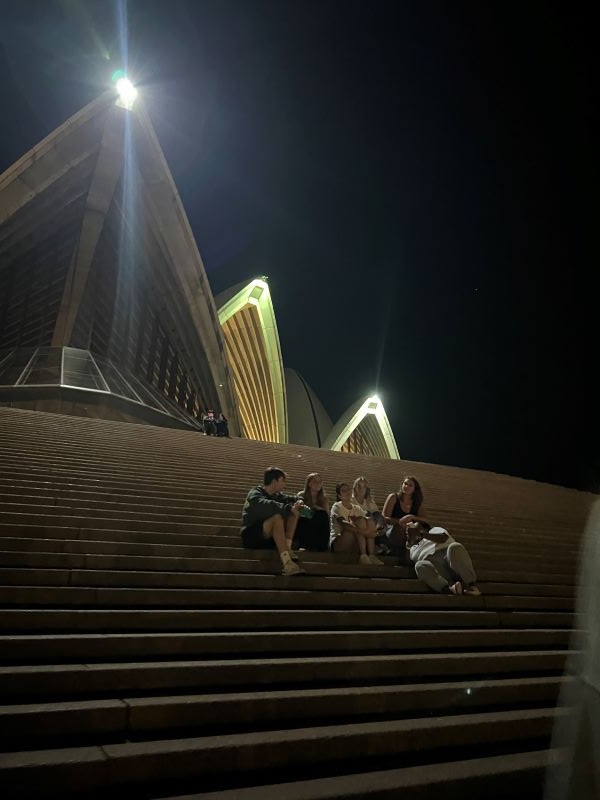 Group of study abroad students sitting on stairs of Sydney Opera House