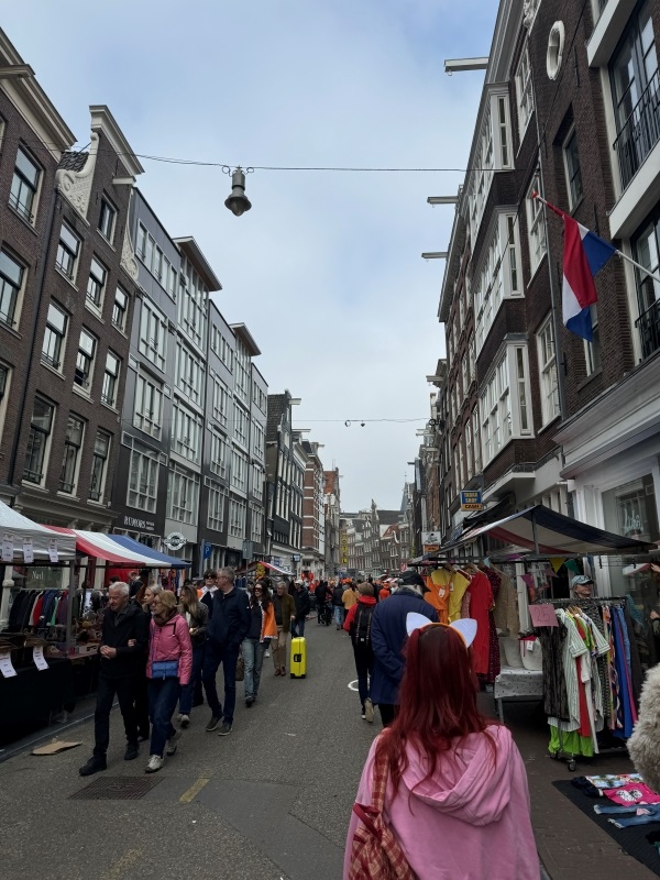 Photo of busy Amsterdam street filled with people and vendors