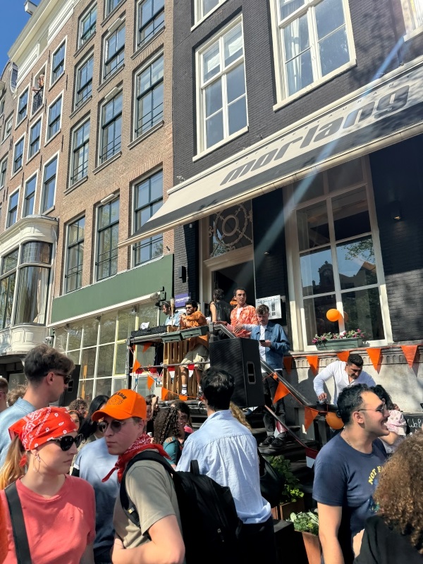 DJ set in entryway of business with large crowd