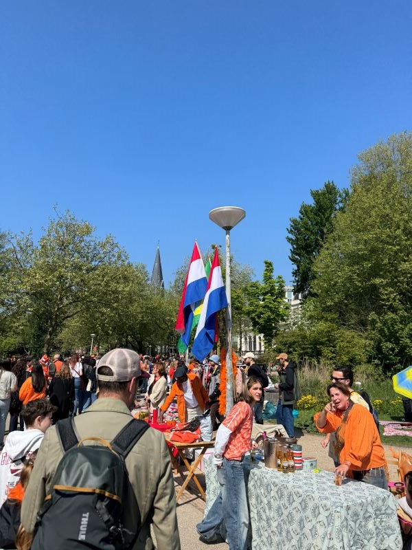 Photo of food vendors wearing orange with large crowd