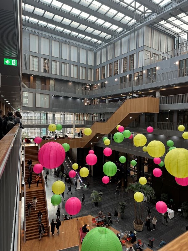 Lobby of new building with hanging brightly colored lanterns 