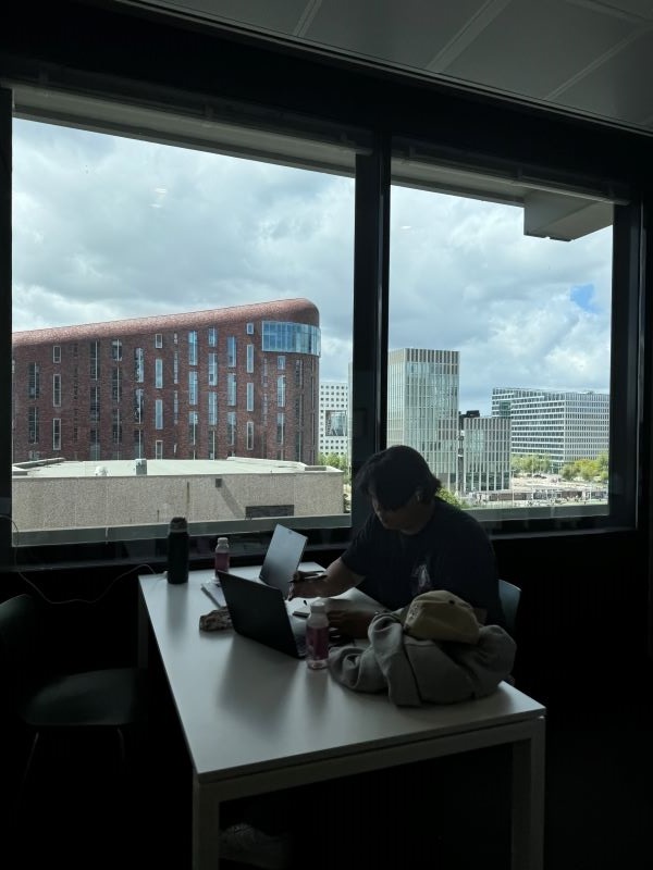 Study abroad student studying at table with view of city