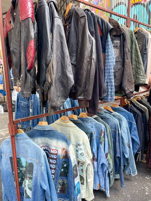 Vintage clothing on racks in street