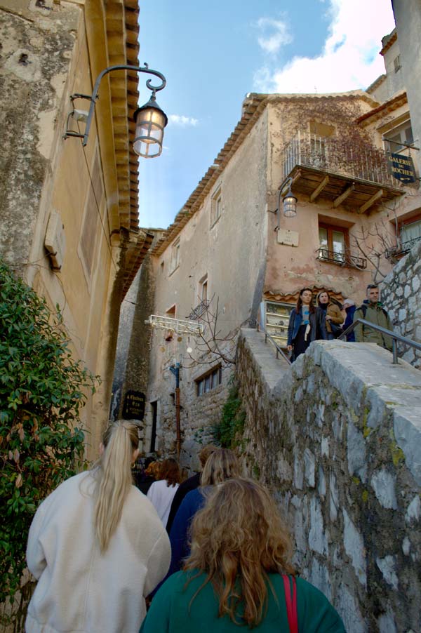 A group of study abroad students walking down a narrow street