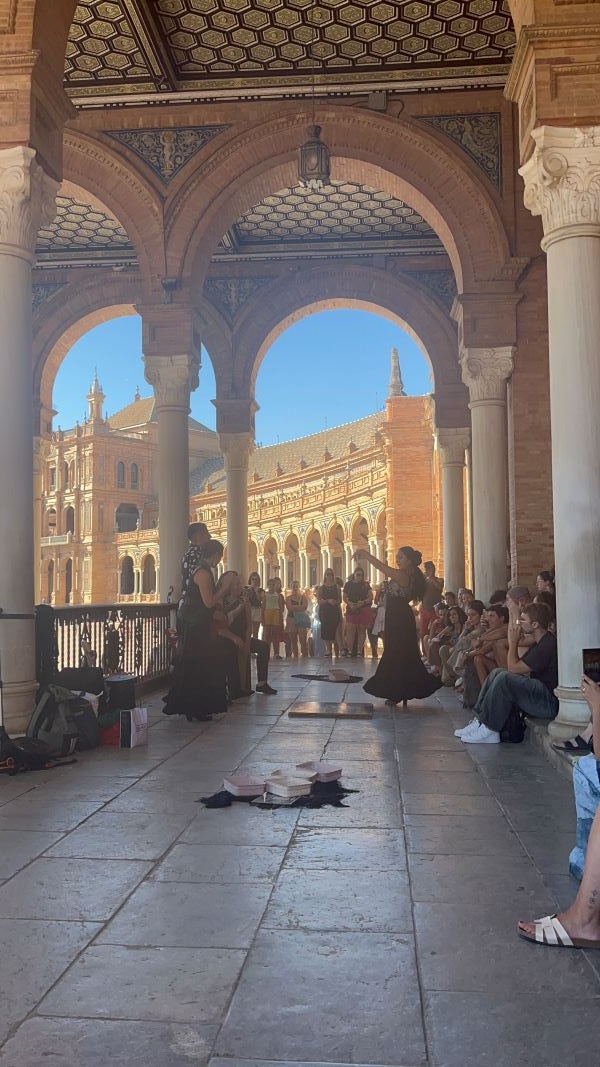 Flamenco street performer dancing in front of crowd