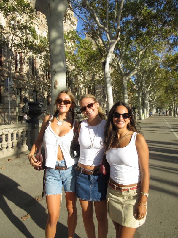Three study abroad students posing for photo on street