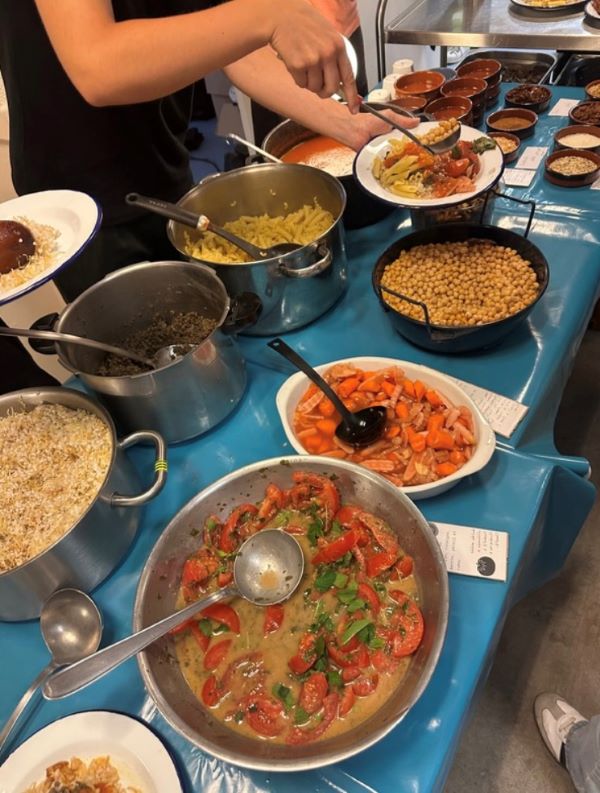 A table laden with many plates and bowls of food