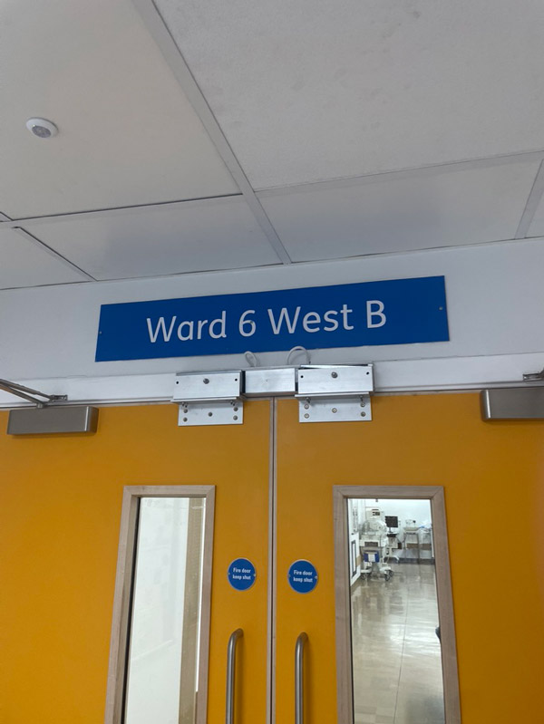 Doors with a sign above that reads ward 6 west b