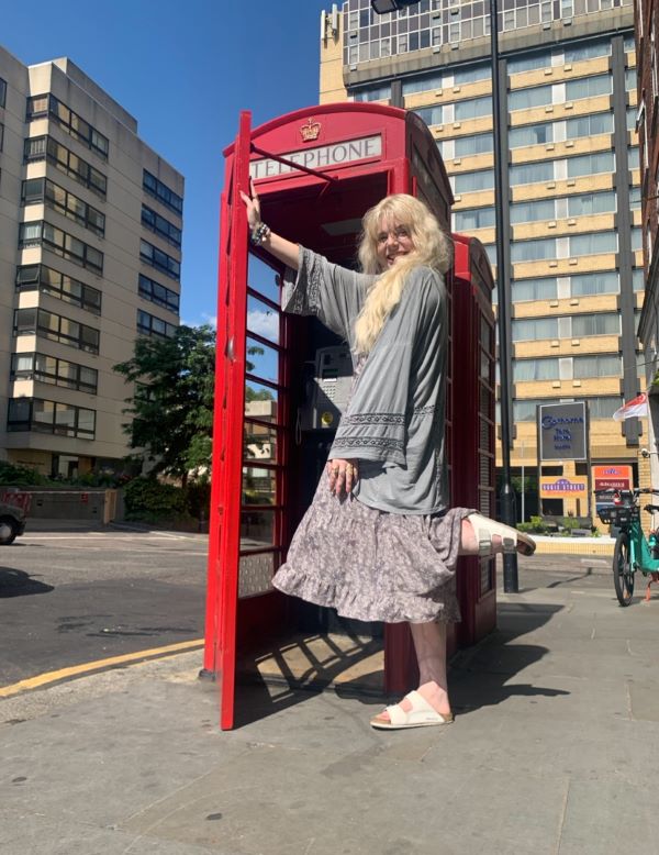 Photo of study abroad student in a red telephone booth in London