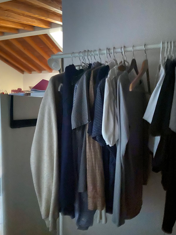 A closet with clothes on a rod