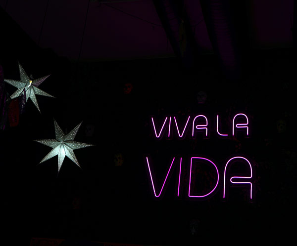 a sign with neon letters and stars