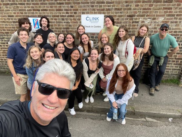 Selfie of professor and study abroad students in front of The Clink Restaurant at HMP Brixton