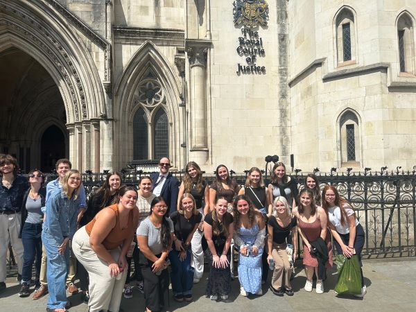 Study abroad cohort posing for photo in front of Royal Courts of Justice building