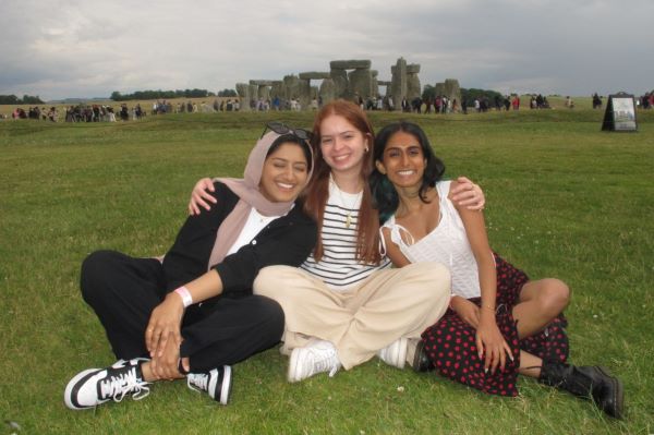Three study abroad students posing for photo in front of Stonehenge