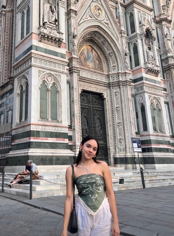 A person standing in front of a cathedral