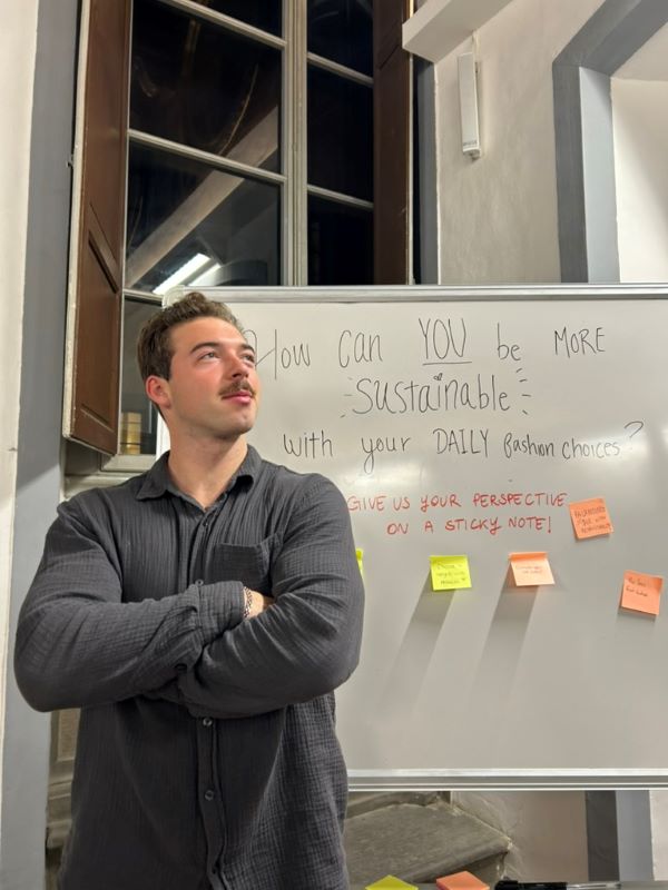 Study abroad student posing for photo in front of whiteboard