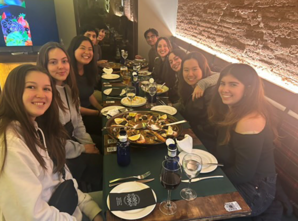 Large group of study abroad students eating paella at restaurant 