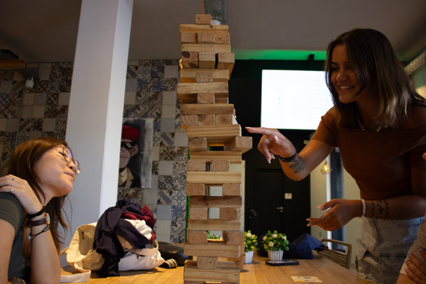 Study abroad friends playing a game with a wooden block tower
