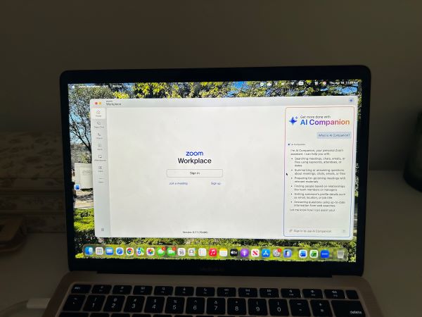 A brightly-lit laptop screen featuring a white square with the words