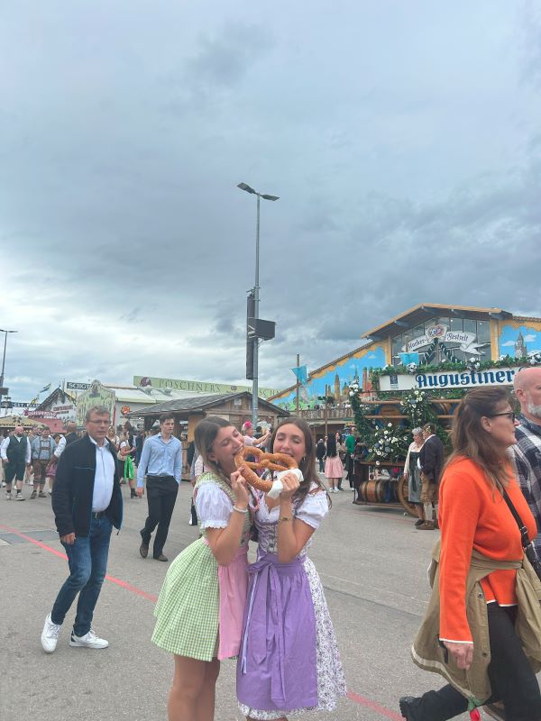 Two study abroad students sharing a pretzel at Oktoberfest 