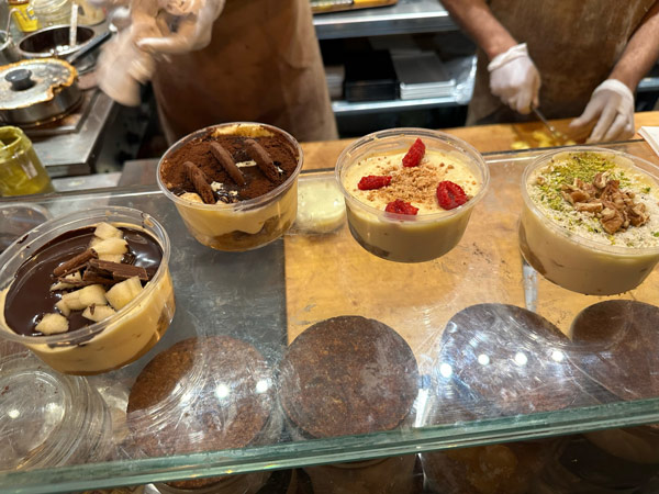 A group of desserts in plastic cups