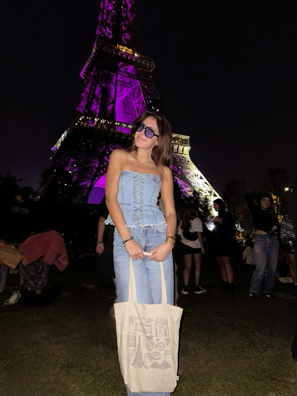 A person standing under the Eiffel Tower