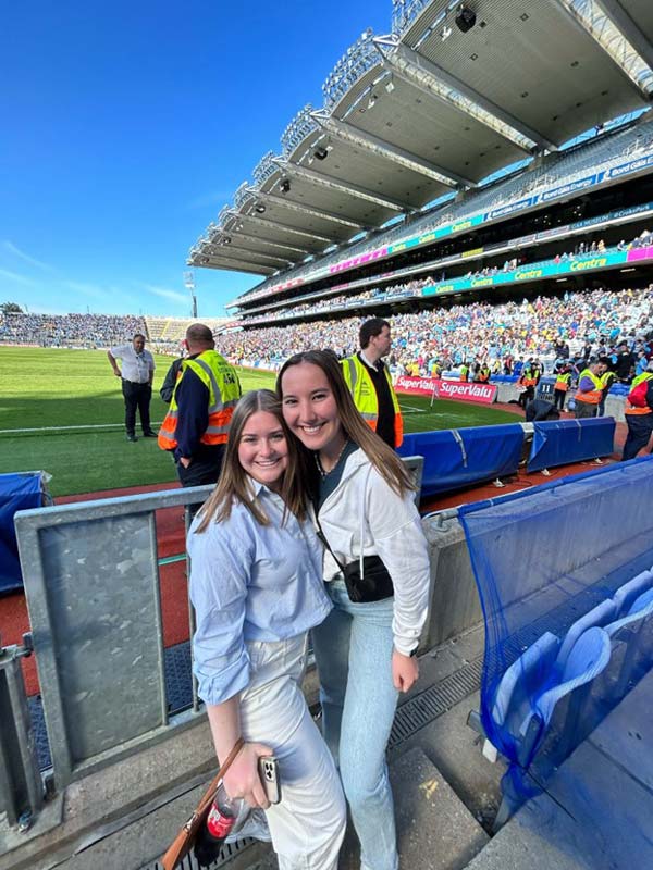 Two study abroad students standing in a stadium