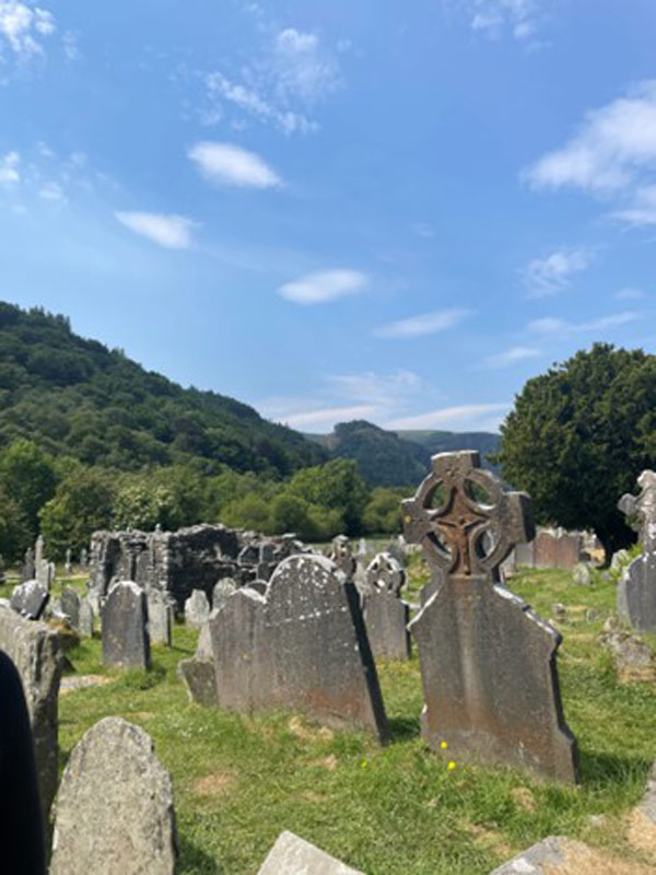 A cemetery with a hill in the background