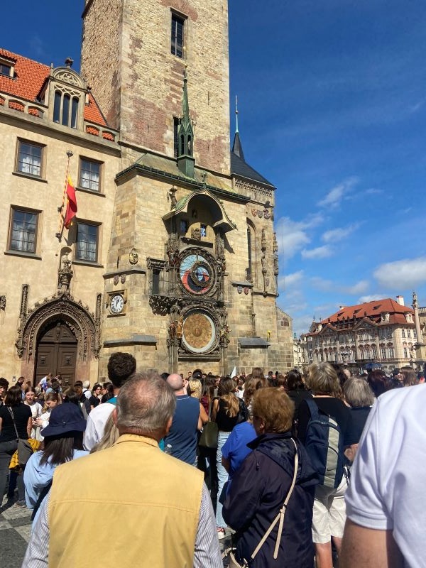 Large crowd of civilians looking at the  Astronomical clock tower