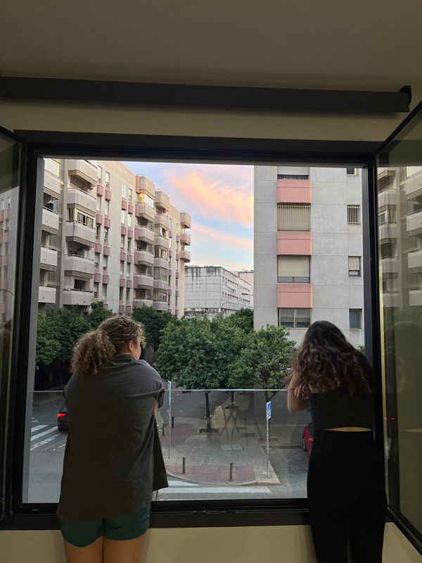 Two study abroad students looking out a window