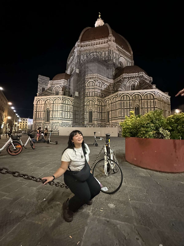 A study abroad student sitting in front of a large building