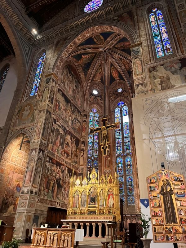 An intricately decorated interior space with large stained-glass windows
