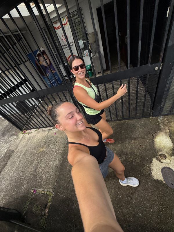 Two study abroad students as seen from above taking a selfie while walking on a city street