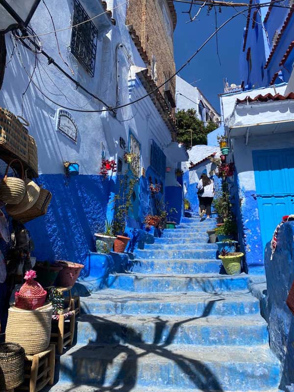 A blue staircase with a person walking down it
