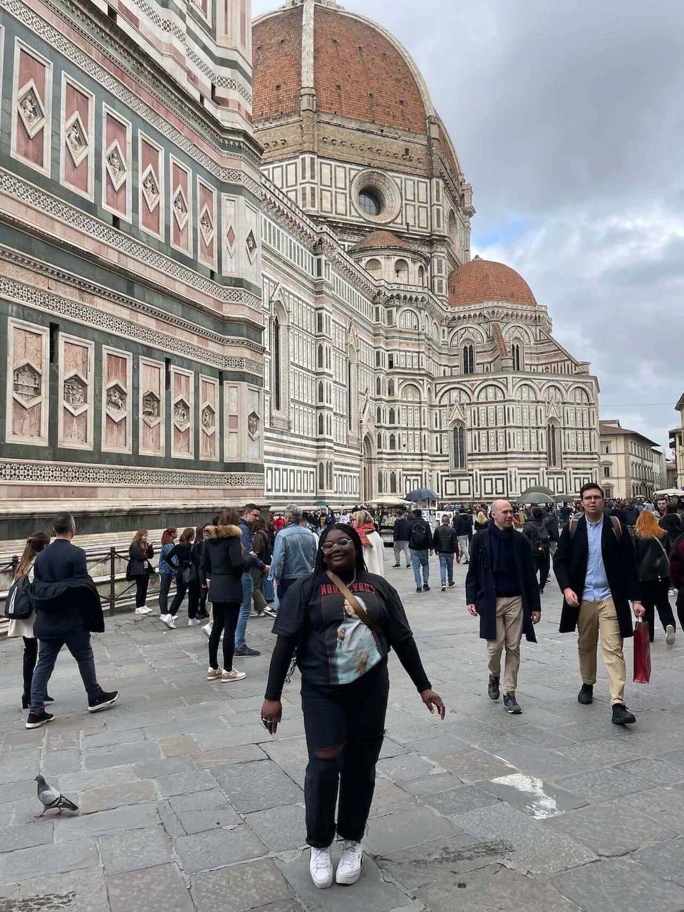 A student in the center of a crowd by the duomo in Florence, Italy