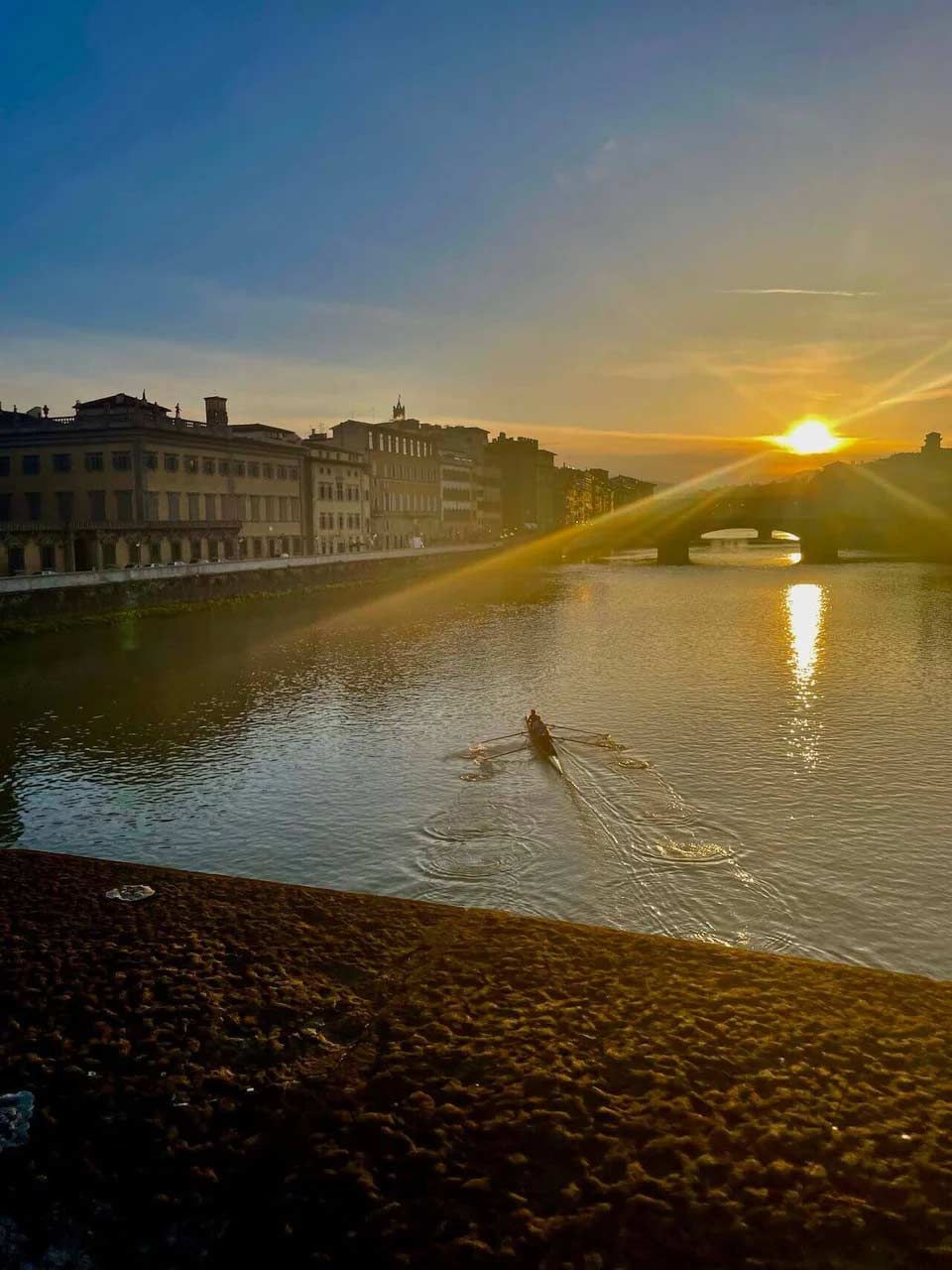 Sunrise over Ponte Vecchio with a kayaker on the water