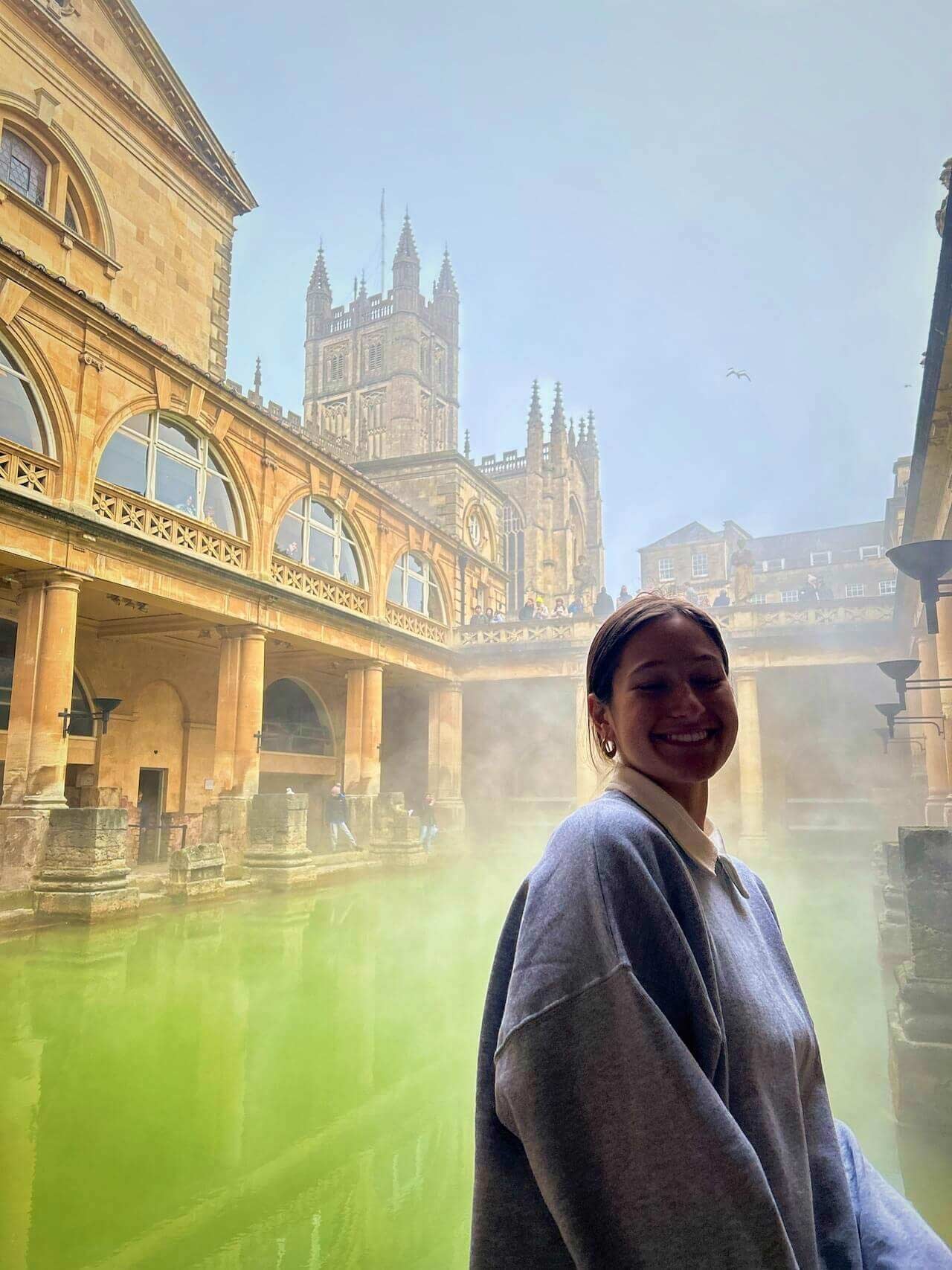 A person standing by the ancient Roman Baths in Bath, England