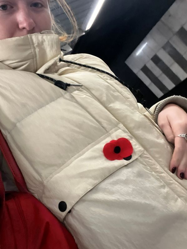 Selfie of study abroad student with poppy pin on vest