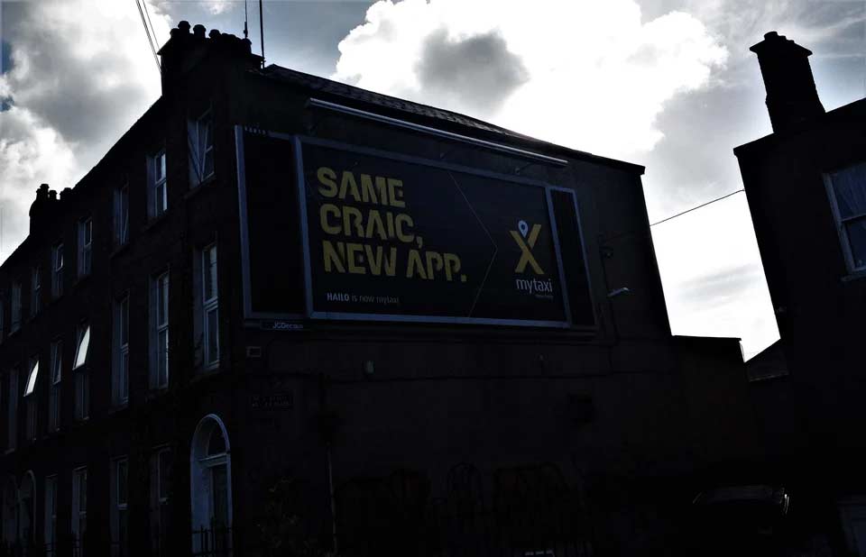 Billboard on a building saying 'New Craic. Same App.'