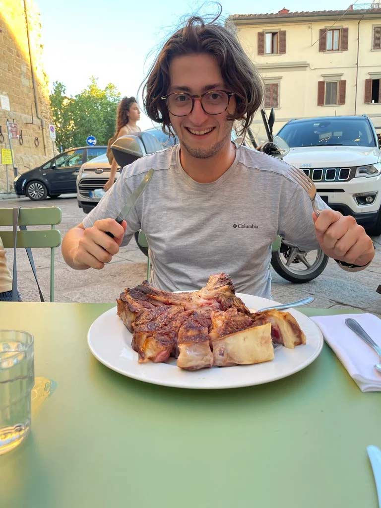 Friend having a steak in Florence.